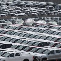 Toyota vehicles bound for export sit in a lot at Nagoya port in Aichi Prefecture. Japan logs trade surplus of ¥1.04 trillion in first half