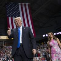 President Donald Trump and first lady Melania Trump arrive for a rally Tuesday at the Covelli Centre in Youngstown, Ohio. Apple CEO promised to build three 'big' plants in U.S., Trump tells WSJ