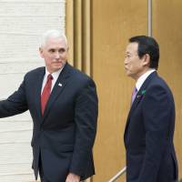 Deputy Prime Minister Taro Aso, who doubles as finance minister, and U.S. Vice President Mike Pence, arrive for a joint news conference after the U.S.-Japan economic dialogue in Tokyo on April 18. | BLOOMBERG
