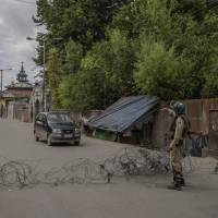 Indian paramilitary soldiers stand guard at a temporary checkpoint during a curfew in downtown Srinagar in Indian-controlled Kashmir on June 30. Al-Qaida to fight Indian rule in Kashmir