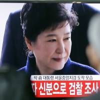 People watch a TV news program showing ousted South Korean President Park Geun-hye’s arrival at a prosecutors office, at Seoul Railway Station in March. South Korea lifts court TV ban ahead of ousted president's sentencing