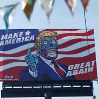 A billboard of U.S. President Donald Trump as a \"They Live\"-style alien stands beside Periferico Avenue in Mexico City on Friday. | REUTERS