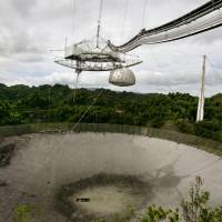 The Arecibo Observatory’s single-dish radio telescope is seen in Puerto Rico in May 2007. Mystery of 'peculiar' radio signals tracked from nearby star may be solved this week