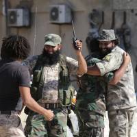 Members of the Libyan army’s special forces celebrate after the liberation of the last region of Islamist militants in their last stronghold in Benghazi, Libya, Wednesday. Libya's eastern commander declares victory in battle against Islamists for Benghazi