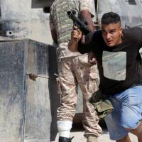 A member of Libyan National Army (LNA) runs for cover during clashes with Islamist militants in the militants’ last stronghold in Benghazi, Libya, Thursday. Libya forces in 'liberated' Benghazi continue to fight jihadis
