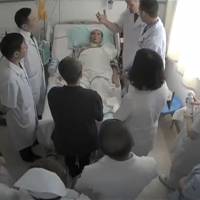 Liu Xiaobo is surrounded by doctors and his wife, Liu Xia, in an undated screen shot obtained Tuesday. Nobel laureate Liu Xiaobo suffers organ failure, hospital says, amid questions over Beijing's news blackout