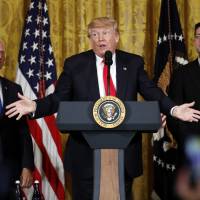 President Donald Trump, flanked by Vice President Mike Pence (left) and House Speaker Paul Ryan, speaks in the East Room of the White House Wednesday in Washington. In nod to Trump, House Republicans ready bill with taxpayer-funded downpayment on Mexico border wall