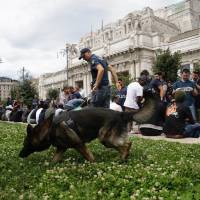 Italian Police check people during a blitz outside Milan’s main train station Wednesday. Authorities have detained several dozen people in response to an increasing public security issue as the city deals with a new wave of migrants. Milan police collar dozens of migrants in sweep of main train station