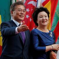South Korean President Moon Jae-in and his wife, Kim Jung-sook, attend the Group of 20 summit in Hamburg, Germany, on Friday. | REUTERS