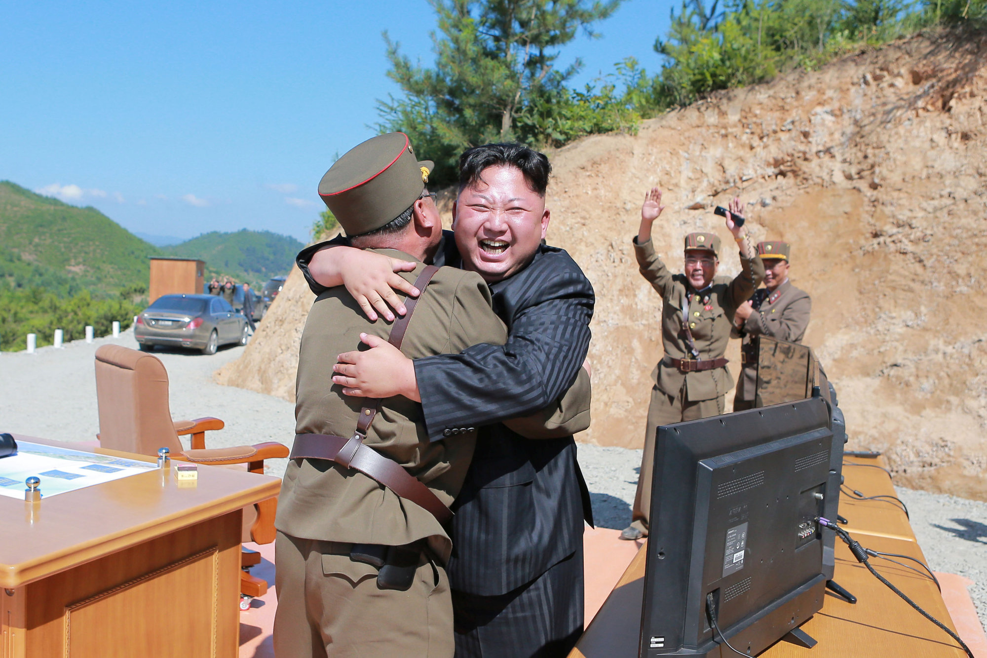 North Korean leader Kim Jong Un reacts with scientists and technicians of the country's Academy of Defense Science after the test-launch of the Hwasong-14 intercontinental ballistic missile Tuesday. | KCNA / VIA REUTERS