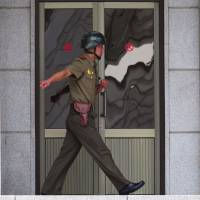 A North Korean soldier moves to a positon on the north side at the truce village of Panmunjom in the Demilitarized Zone dividing the two Koreas on Wednesday. North Korea tourism agency pitches surfing and 'theme tours' but U.S. says travelers beware