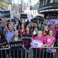 Protestors gather in Times Square Wednesday in New York. President Donald Trump declared a ban Wednesday on transgender troops serving anywhere in the U.S. military, catching the Pentagon flat-footed and unable to explain what it called Trump\'s \"guidance.\" His proclamation, on Twitter rather than any formal announcement, drew bipartisan denunciations and threw currently serving transgender soldiers into limbo. | AP