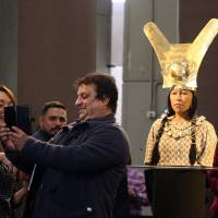 People take a selfie of a replica of The Lady of Cao face, a female mummy found at the archaeological site Huaca El Brujo, a grand pyramid of the ancient Moche pre-hispanic culture, at the Ministry of Culture in Lima Tuesday. Peru taps 3-D tech to re-create face of mummified, tattooed high priestess who died 1,700 years ago