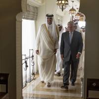The Emir of Qatar, Sheikh Tamim Bin Hamad Al Thani, welcomes U.S. Secretary of State Rex Tillerson to Sea Palace, his official residence, in Doha, Qatar, on Tuesday.  Tillerson visited Qatar while trying to mediate a dispute between the energy-rich country and its Gulf neighbors. | AP