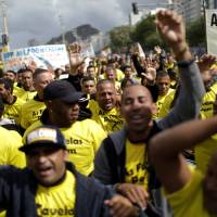Residents of several slums protest over violence on Copacabana beach in Rio de Janeiro Sunday. Rio's poor favela ranks rally on Copacabana beach to plead for end to deadly shootouts between police, drug gangs