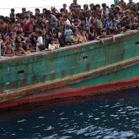 Rohingya migrants drift in Thai waters off the southern island of Koh Lipe in the Andaman Sea in 2015. A Thai general was among several officials convicted Wednesday of running a brutal trade that left desperate Rohingya and Bangladehsi migrants stranded on boats and in jungle death camps. Tens of thousands of migrants were crammed over the years onto often barely sea worthy vessels to be ferried across the Andaman Sea to southern Thailand. | AFP-JIJI
