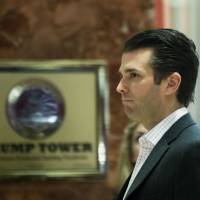 Donald Trump Jr. walks around Trump Tower in New York in December. Donald Trump\'s eldest son on Monday admitted meeting a Russian lawyer to get dirt on his father\'s 2016 rival, Hillary Clinton, thrusting the White House deep into another Russia-related scandal. Trump junior confirmed reports that he was on the trail of damaging information on the Democrat vying to become America\'s first woman president, when he met Natalia Veselnitskaya in June 2016. | AFP-JIJI