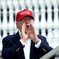 U.S. President Donald Trump shouts to supporters as he arrives at the U.S. Women\'s Open golf tournament at Trump National Golf Club in Bedminster, New Jersey, on Saturday. | REUTERS