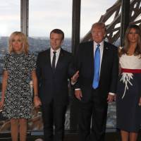 Preparing for dinner (from left) Brigitte Macron, wife of French President Emmanuel Macron; Emmanuel Macron; U.S. President Donald Trump; and first lady Melania Trump pose at the Jules Verne restaurant in the Eiffel Tower in Paris Thursday. | YVES HERMAN / POOL PHOTO / VIA AP