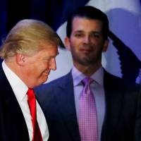 Donald Trump Jr. watches his father, Republican U.S. presidential candidate Donald Trump, leave the stage on the night of the Iowa Caucus in Des Moines, Iowa, on Feb. 1, 2016. Trump blames media as Russia scandal swirls; aides privately acknowledge seriousness of revelations