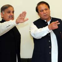 Former Pakistani Prime Minister Nawaz Sharif (right) arrives with his brother Shahbaz Sharif for a news conference in Lahore on Feb. 25, 2009. Ousted Pakistani leader Sharif names brother Shahbaz as successor