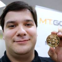 Mark Karpeles poses with a bitcoin in the offices of Mt. Gox in Tokyo in April 2013. Mt. Gox CEO Mark Karpeles braces for bitcoin trial in Japan