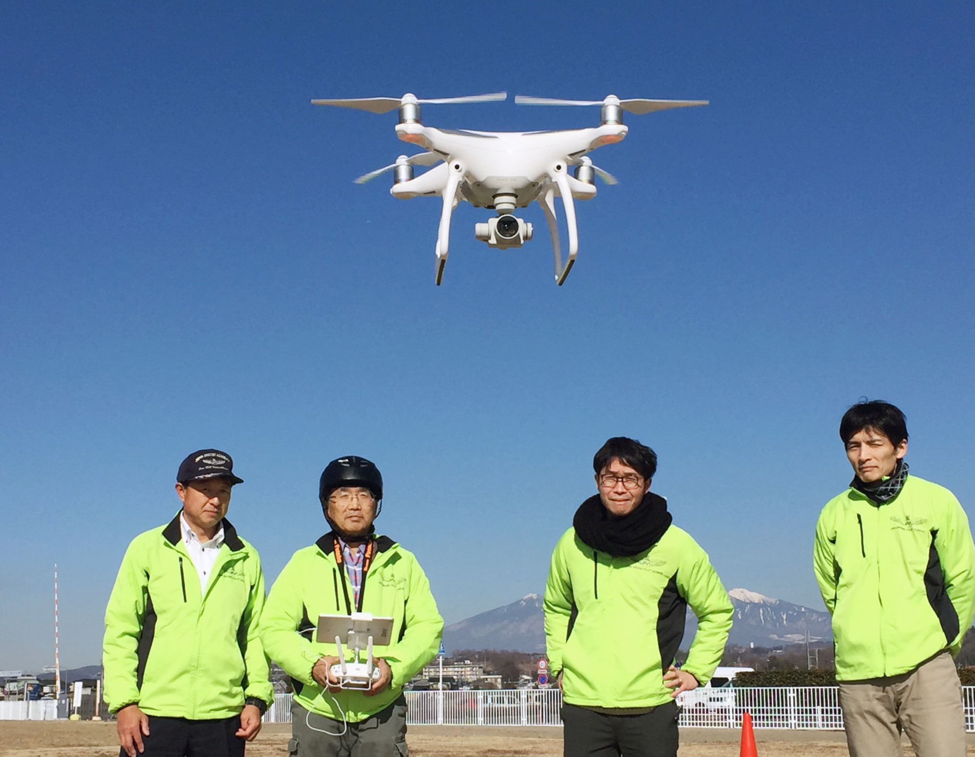 A teacher shows how to fly a drone during a class in this handout photo taken in Kai, Yamanashi Prefecture in March. | KYODO