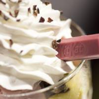 A Kit Kat bar sits in a parfait during a media preview of Nestle Japan\'s Chocolatory Ginza store. | BLOOMBERG