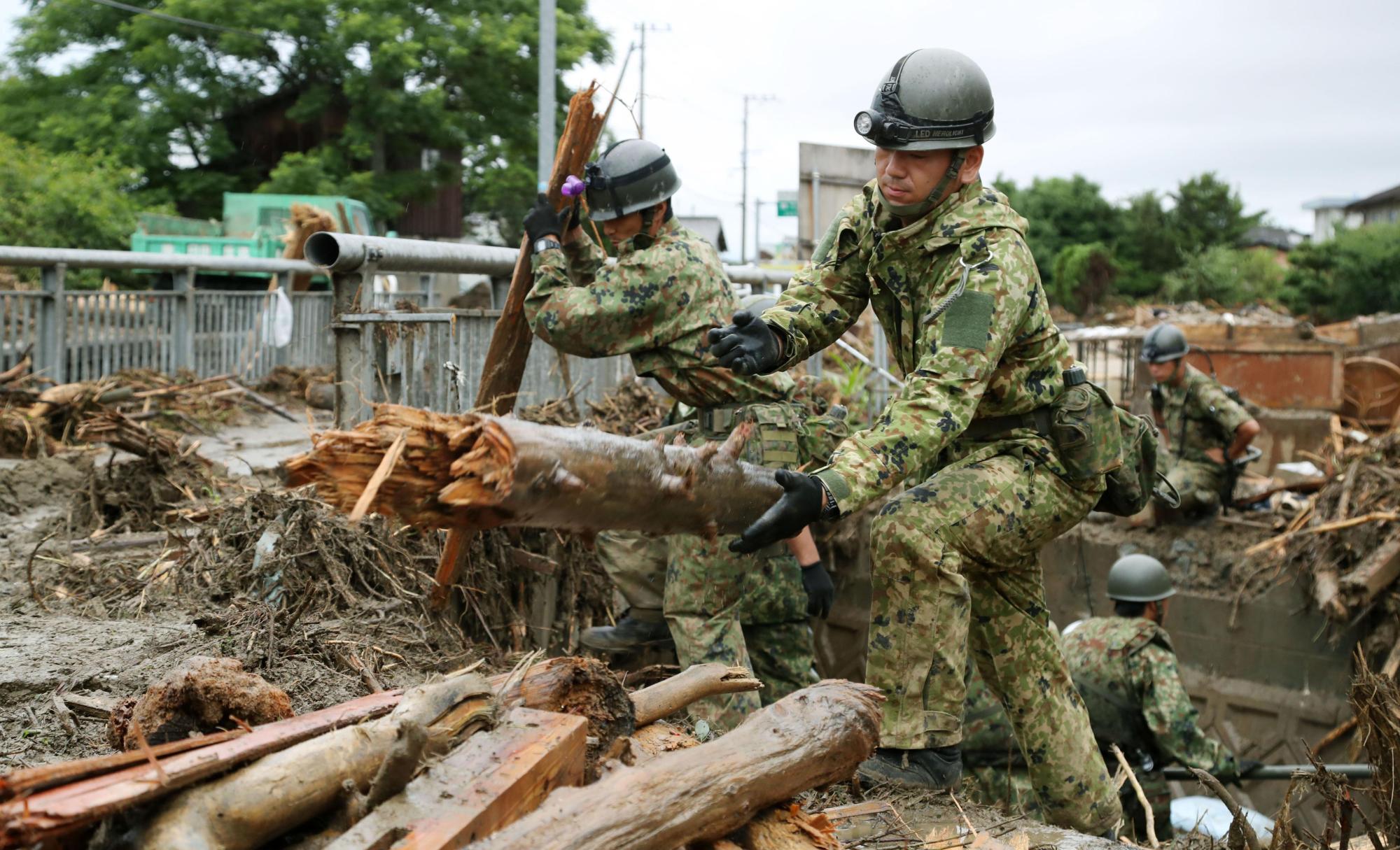 Members of the Self-Defense Forces search for missing people in Asakura, Fukuoka Prefecture, on Sunday. | KYODO