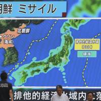 People walks past a public TV screen broadcasting news of North Korea\'s ballistic missile which landed in the waters of Japan\'s economic zone in Tokyo on Tuesday. | AP
