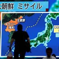 Passers-by in Tokyo on Tuesday look at a large monitor showing news of North Korea’s intercontinental ballistic missile test. North Korean claim of successful ICBM test likely to raise alarm in Tokyo — and Anchorage