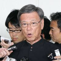 Okinawa Gov. Takeshi Onaga speaks to reporters in Naha in June. Takeshi Onaga loses majority in Naha Municipal Assembly race