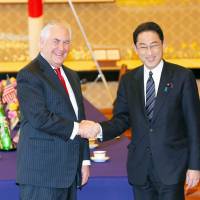 U.S. Secretary of State Rex Tillerson (left) is greeted by Foreign Minister Fumio Kishida in March during his visit to Tokyo. Sources said foreign and defense ministers of Japan and the United States are planning to hold security talks next month. | POOL / VIA KYODO