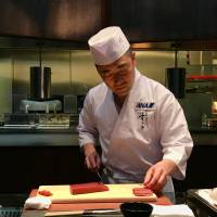 A cut above: Sushi maestro Takaaki Sugita demonstrates his knife skills in Barcelona. Robbie Swinnerton | ROBBIE SWINNERTON