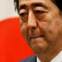 Cracks in the Teflon: Embattled Prime Minister Shinzo Abe attends a news conference at his official residence in Tokyo on June 19 after the close of the regular Diet session. Tokyo poll offers Abe an opportunity to take a long, hard look in the mirror