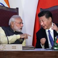 Indian Prime Minister Narendra Modi talks with Chinese President Xi Jinping in Goa, India, last Oct. 16. India and China have faced off frequently since fighting a bloody 1962 war that ended with China seizing control of some territory. It's high noon on the roof the world