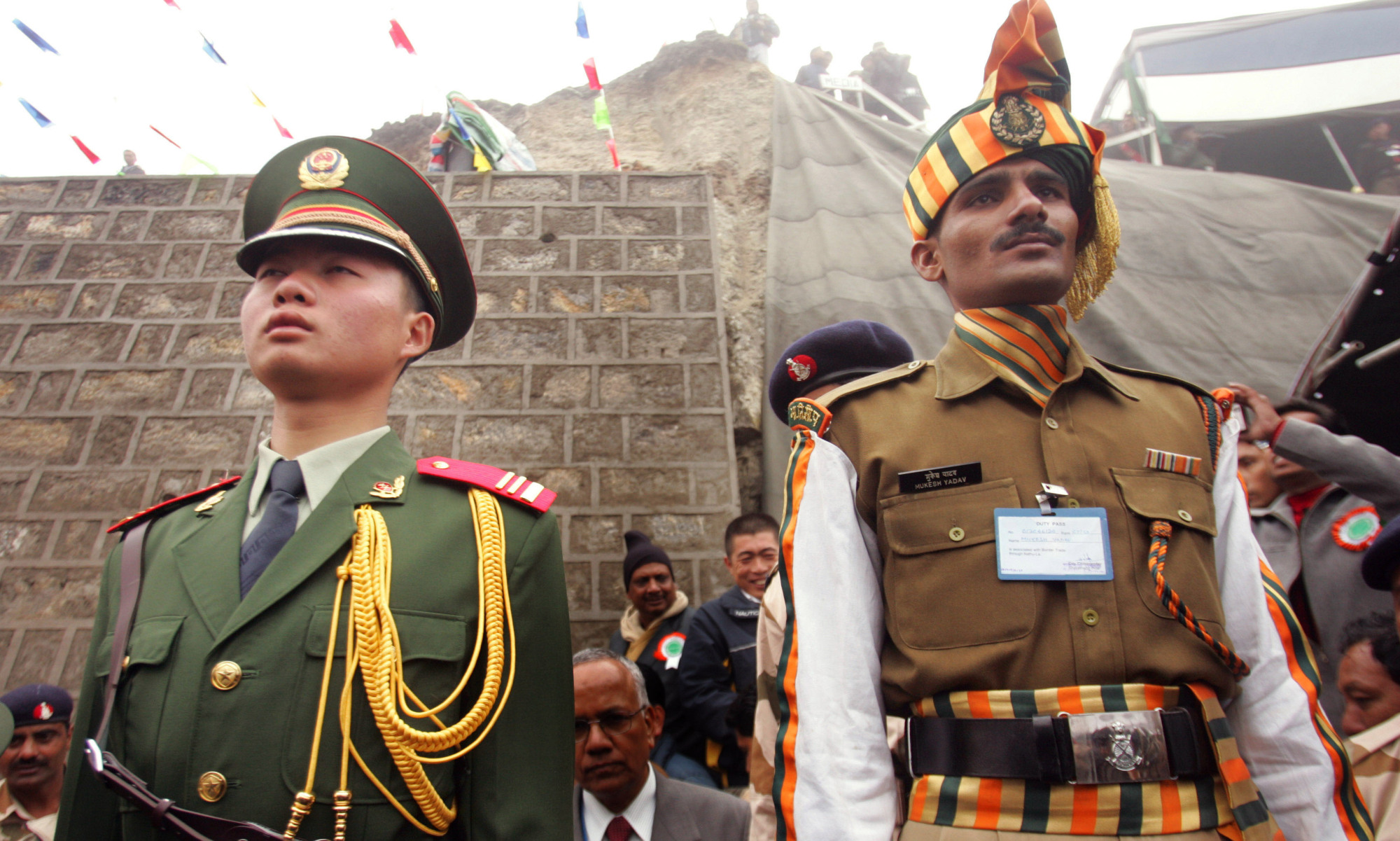 A Chinese soldier and an Indian soldier maintain ceremonial positions marking the borders of their respective countries at the 2006 opening of the Nathu La pass in the northeastern Indian state of Sikkim, which had been closed following military clashes between China and India in 1967. Border tensions are rising  once again between the two Asian giants. | AP