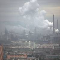 A coal-burning power plant in Taiyuan, Shanxi, belches a cloud of pollution in 2007. In China, electricity production still relies heavily on high-carbon sources including coal. China's electric cars are actually pretty dirty
