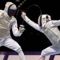 Russia\'s Dmitry Zherebchenko (left) wins the duel against Toshiya Saito during the men\'s individual foil final at the World Fencing Championships on Sunday in Leipzig, Germany. | AP