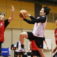 Japan guard Manami Fujioka (center), seen in a file photo from a team training session in April, had 18 points and 10 assists on Tuesday against Australia in a FIBA Women\'s Asia Cup match. | KAZ NAGATSUKA