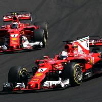 Sebastian Vettel (right) competes against Kimi Raikkonen during the Hungarian Grand Prix on Sunday in Budapest. Vettel won the race. Vettel wins Hungarian Grand Prix