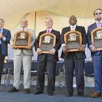 New Hall of Famers (from left) Bud Selig, Ivan Rodriguez, John Schuerholz, Tim Raines Sr., and Jeff Bagwell hold their plaques after their induction ceremony on Sunday. Emotions run high as 2017 class enters Hall