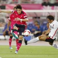 Cerezo Osaka\'s Kenyu Sugimoto shoots the ball against the Urawa Reds on Saturday night at Yanmar Stadium. Sugimoto finished with two goals in Cerezo\'s 4-2 victory. | KYODO