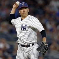 New York’s Masahiro Tanaka throws to first base against Toronto in the seventh inning on Monday. Tanaka delivers for Yankees