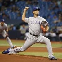 Texas starter Yu Darvish fires a pitch against Tampa Bay on Friday night. Darvish fans 12 in no-decision