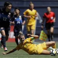 Australia\'s Steph Catley slides for the ball as Japan\'s Hikaru Naomoto looks on during their game on Sunday in San Diego. | AP