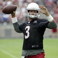 Cardinals quarterback Carson Palmer throws a pass on the first day of training camp on Saturday in Glendale, Arizona. Rejuvenated Cardinals QB Palmer eager to get going
