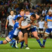 The Sunwolves’ Uwe Helu (center) is tackled during the team’s Super Rugby match against the Stormers on Saturday in Cape Town. Stormers punish Sunwolves for lapses