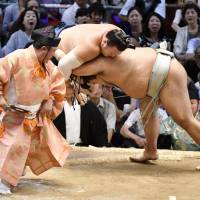 Takayasu (right) shoves Ikioi out of the ring at the Nagoya Grand Sumo Tournament on Monday. | KYODO