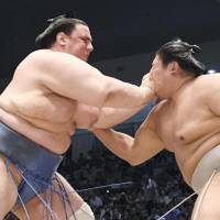 Aoiyama (left) competes against Takanoiwa at the Nagoya Grand Sumo Tournament on Friday. | KYODO
